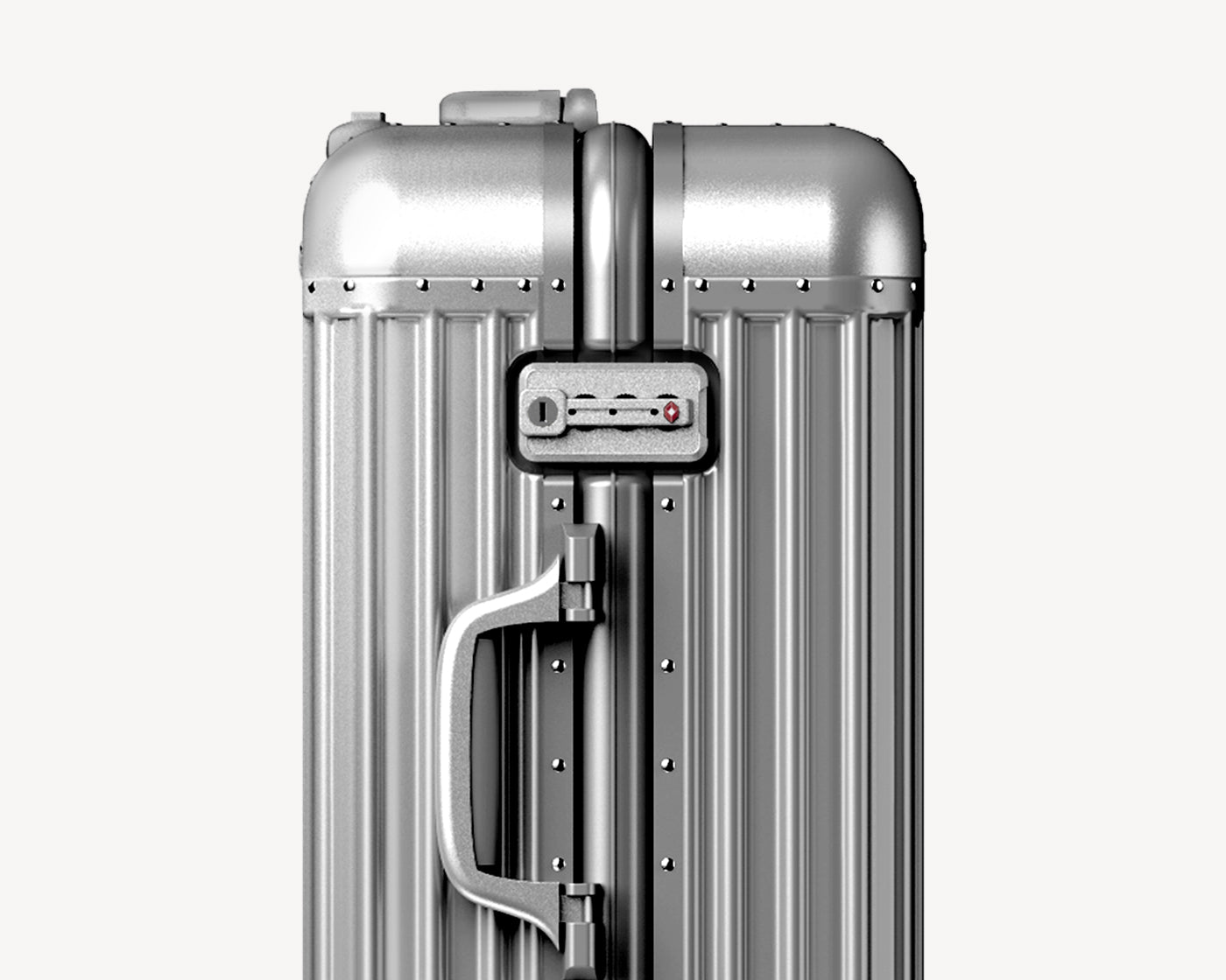Close-up view of a silver metallic suitcase's top handle and telescoping handle mechanism with secure locks and riveted construction.